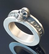 Twelve Small Skull On 7.5mm Wide Side Flat Chiseled Reel Ring